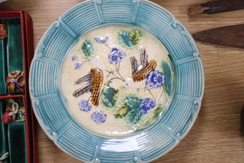 A set of six French earthenware plates, faience plates etc and pottery knife rests